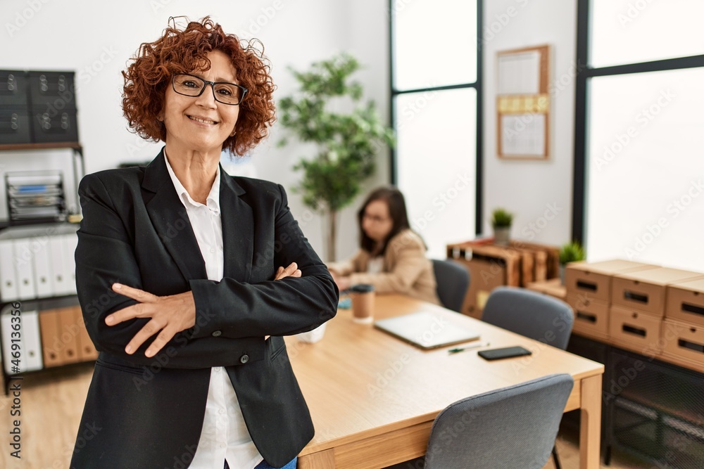 Mature woman working at inclusive teamwork. Group of two women working at the office. Mature woman working at inclusive teamwork. Group of two women working at the office.