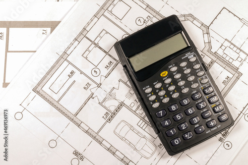 Mortgage calculation of a private country house under construction in the future. The calculator is on the house plan. 