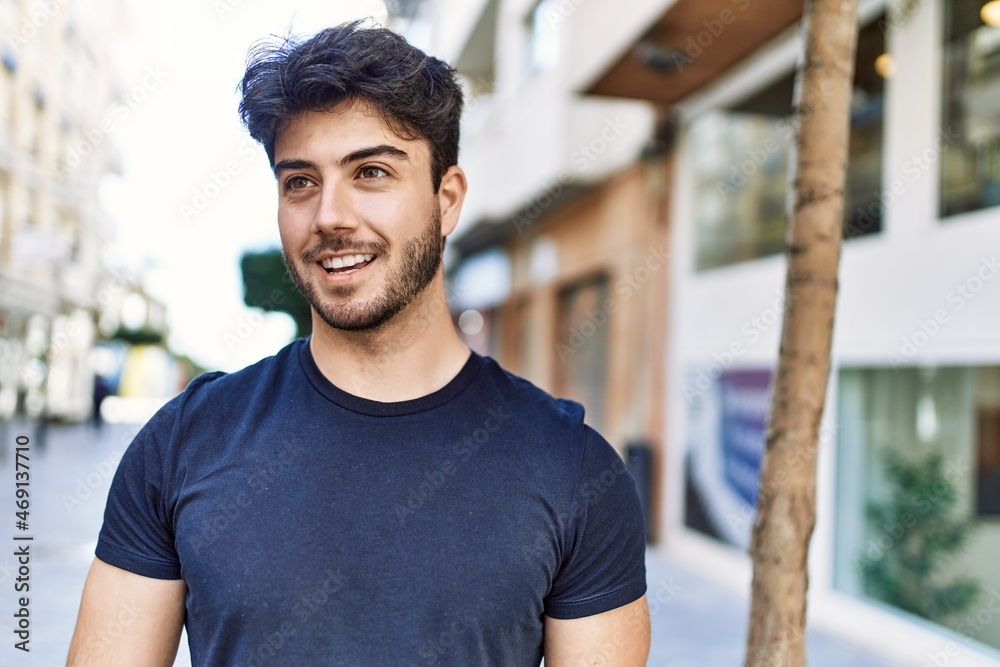Young hispanic man smiling happy standing at the city. Young hispanic man smiling happy standing at the city.