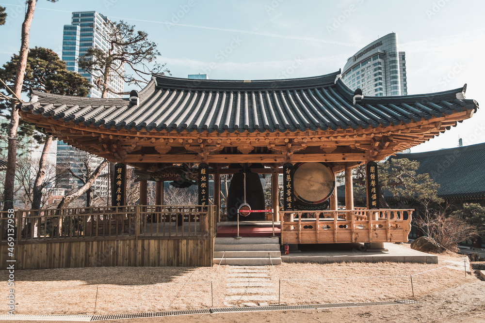 Traditional Asian temple with big roof in metropolis. skyscrapers on the background. Sunny day Traditional Asian temple with big roof in metropolis. skyscrapers on the background. Sunny day