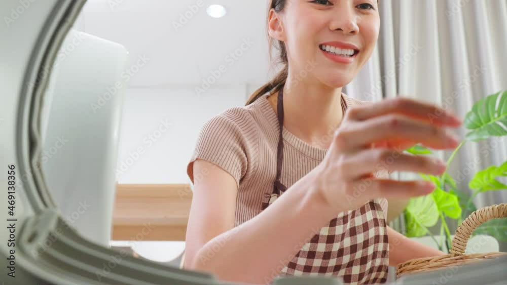 Asian beautiful woman put dirty clothes to washing machine in house. Asian beautiful woman put dirty clothes to washing machine in house.