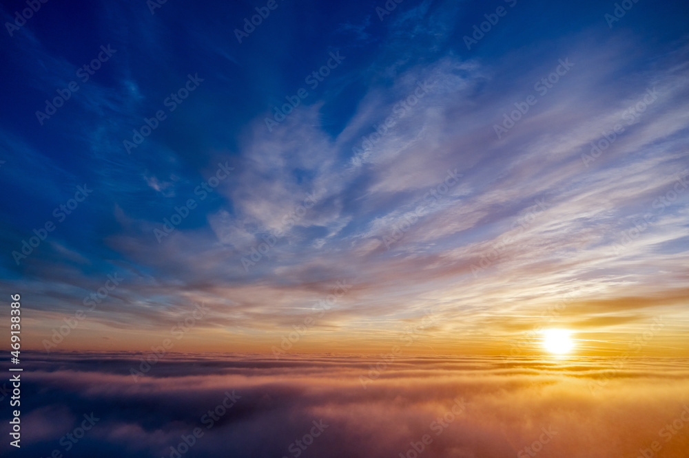 the golden light above the clouds at sunrise