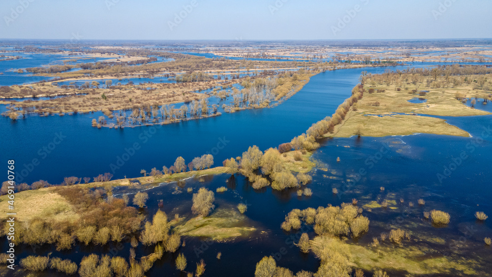 Majestic landscape photographed by drone. Aerial view of freshwater lake with island. Image for design and background.