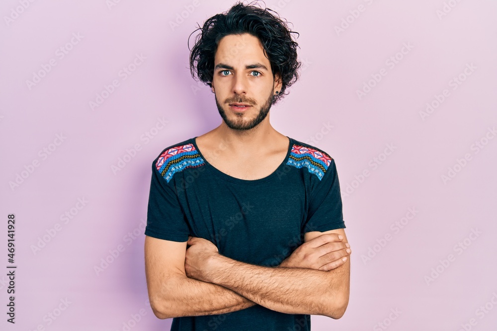 Handsome hispanic man with arms crossed gesture clueless and confused expression. doubt concept. Handsome hispanic man with arms crossed gesture clueless and confused expression. doubt concept.