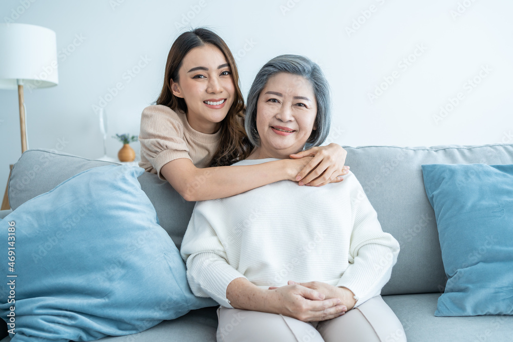 Portrait of Asian lovely family, young daughter hugging older mother. 