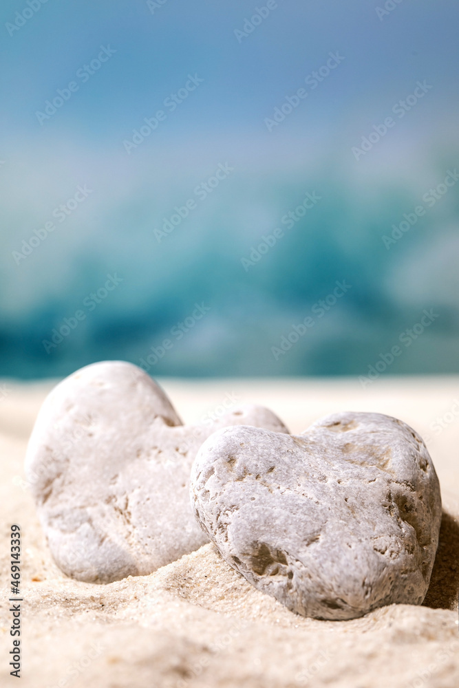 Summer sand sea beach with waves and heart stones