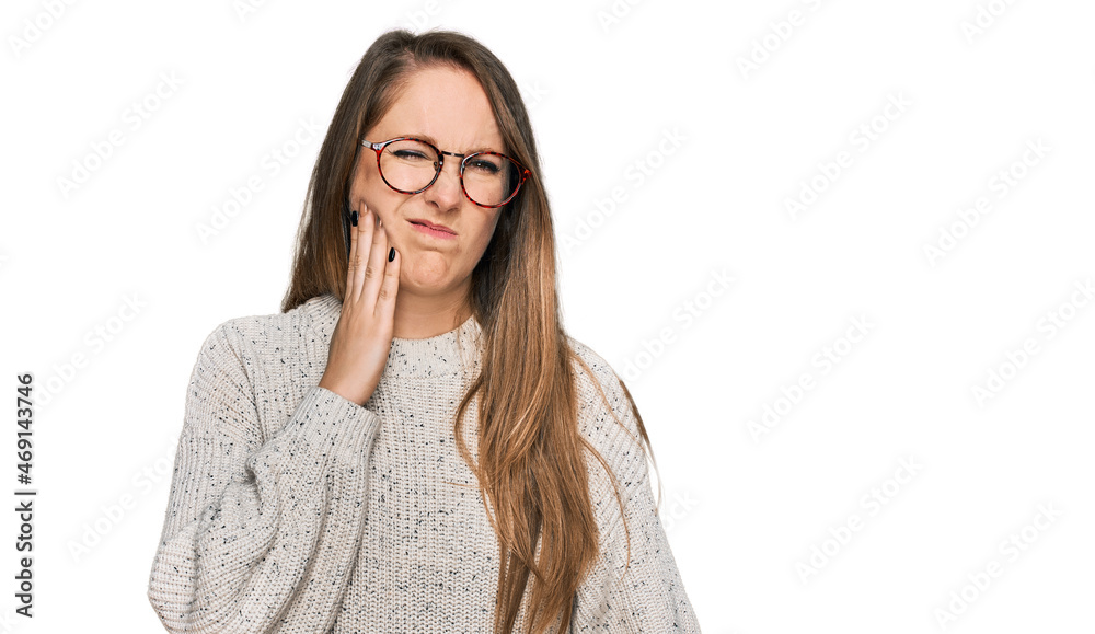 Young blonde woman wearing casual sweater and glasses touching mouth with hand with painful expression because of toothache or dental illness on teeth. dentist Young blonde woman wearing casual sweater and glasses touching mouth with hand with painful expression because of toothache or dental illness on teeth. dentist
