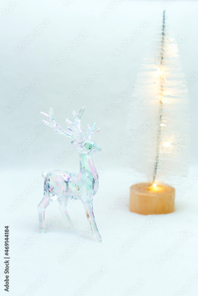 Transparent plastic deer with backlight on a white background. Christmas decoration.