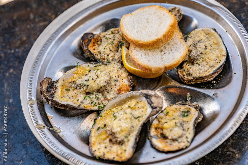 Top view of oysters on the half shell on a table. Shallow focus on chives on the oyster on the left. Top view of oysters on the half shell on a table. Shallow focus on chives on the oyster on the left.