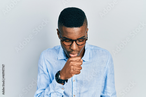 Young african american man wearing casual clothes and glasses feeling unwell and coughing as symptom for cold or bronchitis. health care concept.