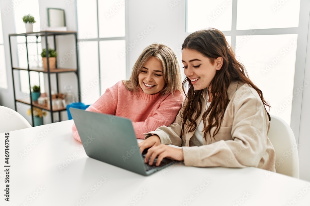 Young couple smiling happy working using laptop at home. Young couple smiling happy working using laptop at home.