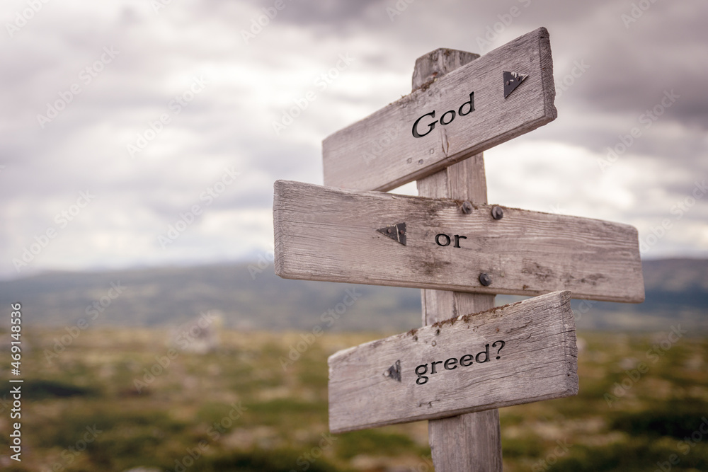 god or greed text on wooden sign outdoors in nature. Religious and christianity quotes. god or greed text on wooden sign outdoors in nature. Religious and christianity quotes.