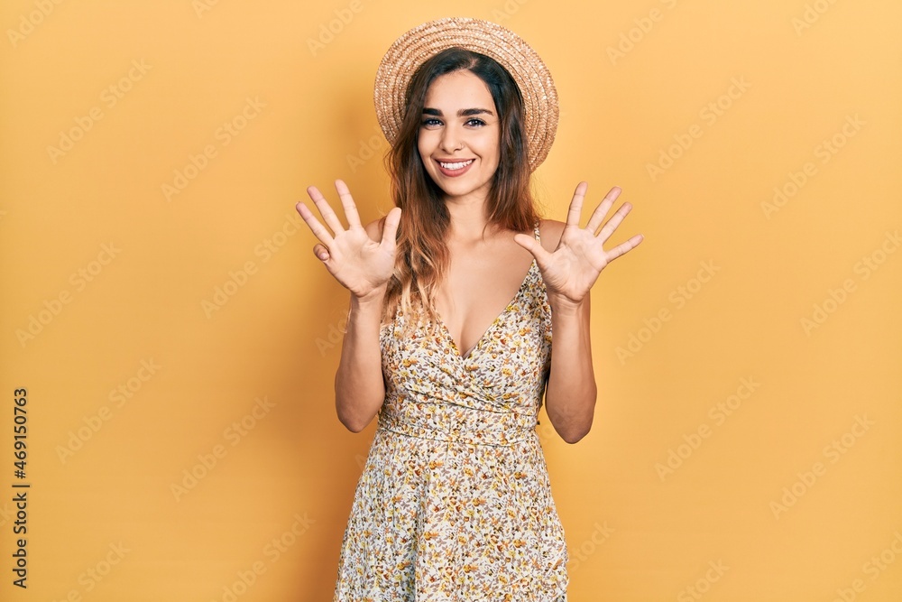 Young hispanic girl wearing summer hat showing and pointing up with fingers number nine while smiling confident and happy. Young hispanic girl wearing summer hat showing and pointing up with fingers number nine while smiling confident and happy.