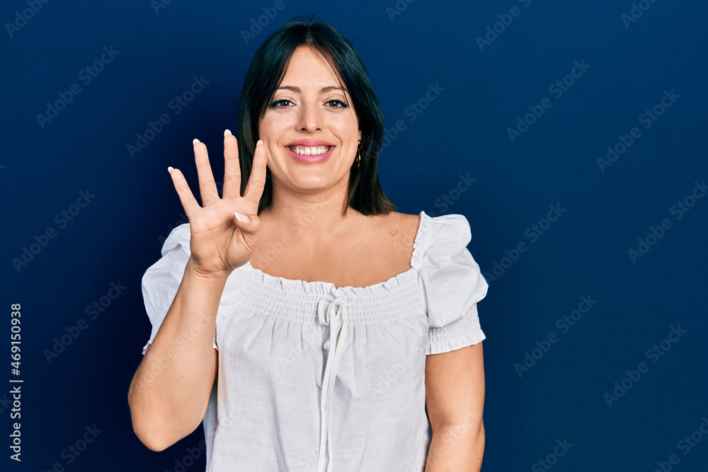 Young hispanic woman wearing casual clothes showing and pointing up with fingers number four while smiling confident and happy. Young hispanic woman wearing casual clothes showing and pointing up with fingers number four while smiling confident and happy.