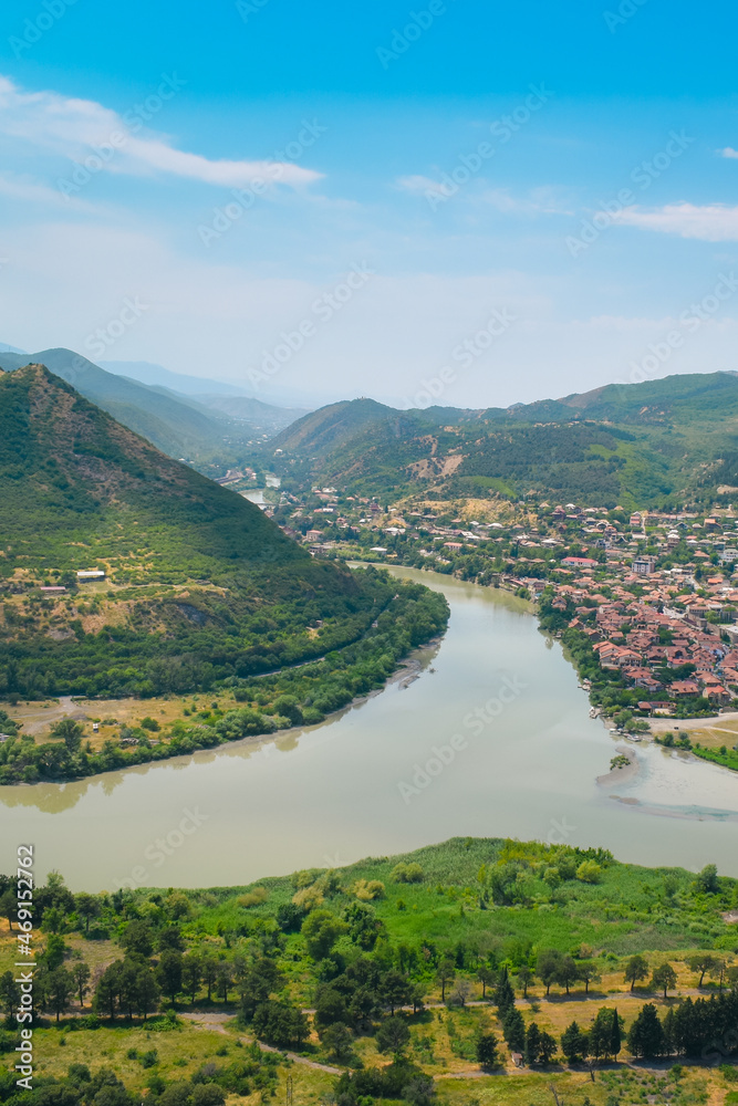 The top view of Mtskheta, Georgia. The historical town lies at the confluence of the rivers Mtkvari and Aragvi. Georgian landscape with blue sky above