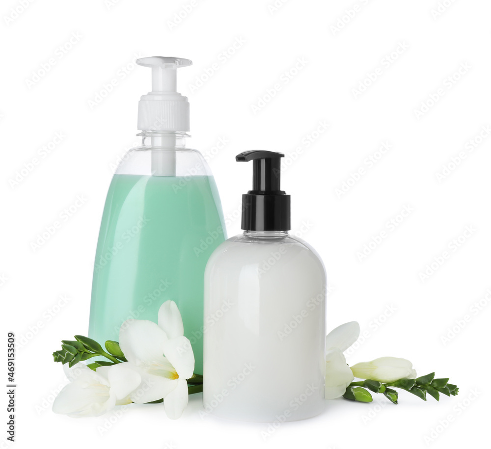 Dispensers of liquid soap and freesia flowers on white background Dispensers of liquid soap and freesia flowers on white background