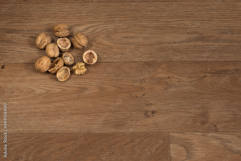 Walnuts on the oak table before christmas time. Waiting for nutcracker. Closed and also already opened walnuts creates true nice feel full of smell of the homemade christmas sweet. Walnuts on the oak table before christmas time. Waiting for nutcracker. Closed and also already opened walnuts creates true nice feel full of smell of the homemade christmas sweet.