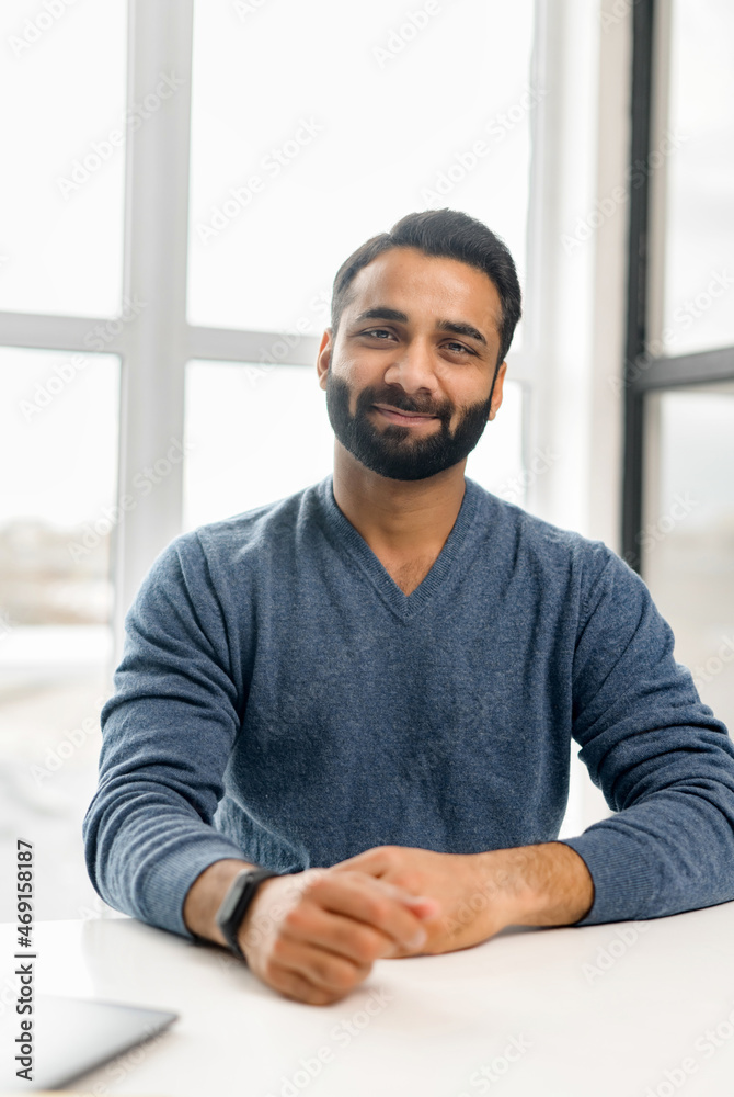 Vertical headshot of Indian man looking at the camera and smiles friendly, video chat with multiracial guy, vertical conference with diverse colleague or friend, screen saver on phone Vertical headshot of Indian man looking at the camera and smiles friendly, video chat with multiracial guy, vertical conference with diverse colleague or friend, screen saver on phone