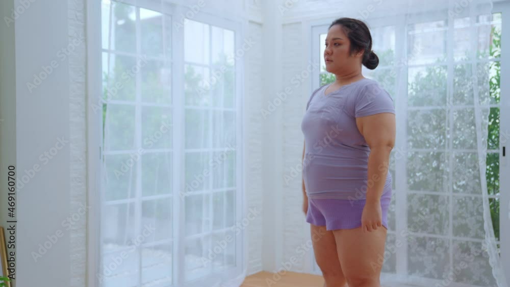Asian woman oversize big chubby girl wear workout clothes exercise by squash and slight stretch after finish. Happiness sports and diet weight loss at home concept. Asian woman oversize big chubby girl wear workout clothes exercise by squash and slight stretch after finish. Happiness sports and diet weight loss at home concept.