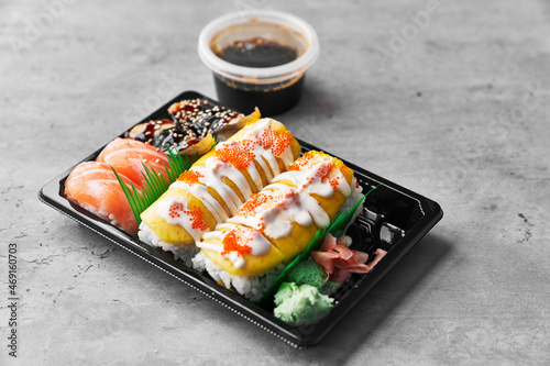  Delivery tray of sushi food on a concrete surface