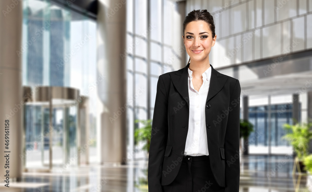 Smiling businesswoman portrait in a modern office Smiling businesswoman portrait in a modern office