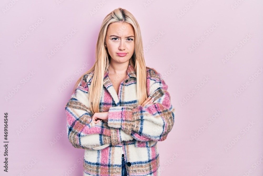 Young blonde girl wearing casual clothes skeptic and nervous, disapproving expression on face with crossed arms. negative person. Young blonde girl wearing casual clothes skeptic and nervous, disapproving expression on face with crossed arms. negative person.