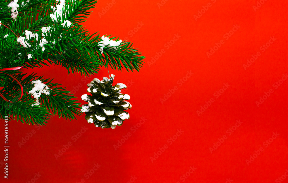 Christmas tree green branch with wooden craft toy. White pine on red background, zero waste concept