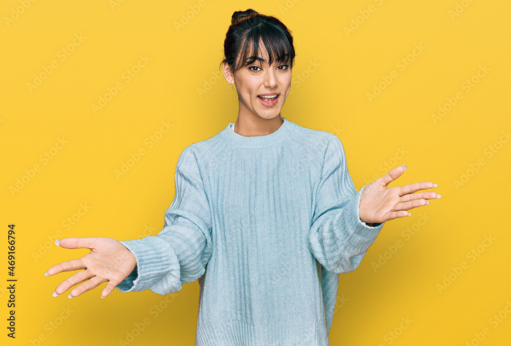 Young hispanic woman wearing casual clothes smiling cheerful offering hands giving assistance and acceptance.