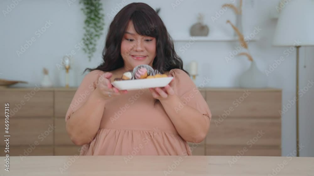 Overweight young fat woman eat donut to sweet food is junk food. Obesity of a female with an appetite while being overweight., appetite control, dieting and health care concept. Overweight young fat woman eat donut to sweet food is junk food. Obesity of a female with an appetite while being overweight., appetite control, dieting and health care concept.