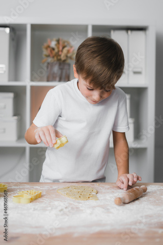 Happy boy child preparing homemade cookies.