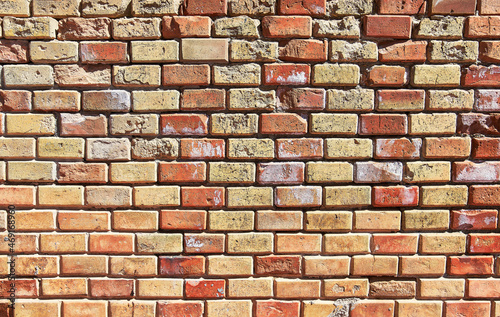 Brick wall texture with cracked tiles and cement. Classic brickwall surface background