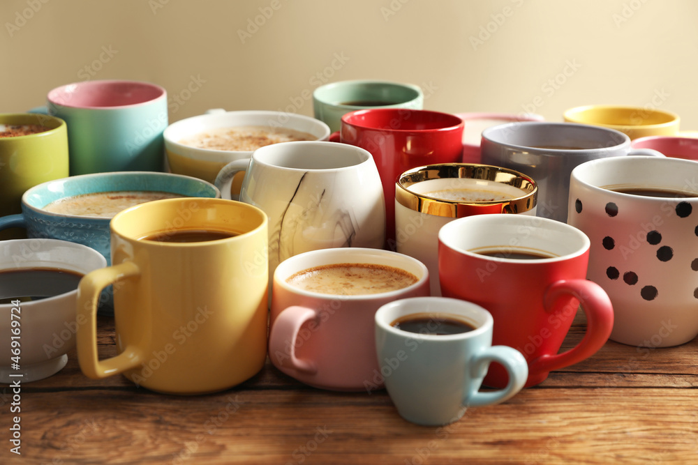 Many cups of different coffees on wooden table Many cups of different coffees on wooden table