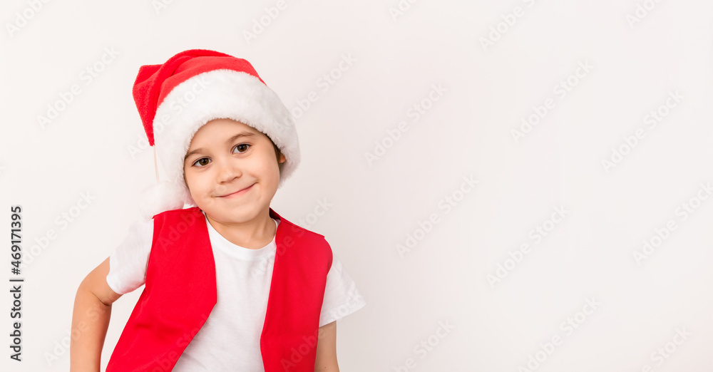 Portrait of smiling beautiful child in red Santa Claus hat isolated on white background. 5 year happy little European boy. Banner. Copy space. Christmas time mockup design. New Year holiday. Fun kid Portrait of smiling beautiful child in red Santa Claus hat isolated on white background. 5 year happy little European boy. Banner. Copy space. Christmas time mockup design. New Year holiday. Fun kid