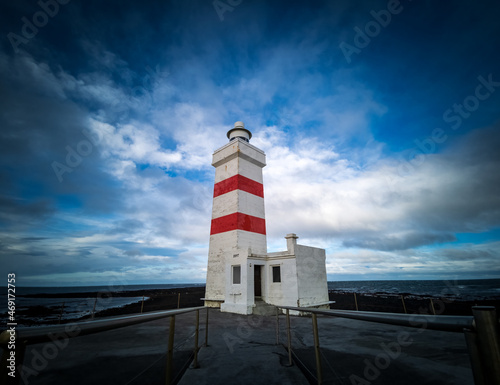 Isolated lighthouse under the cloudy sky in Iceland