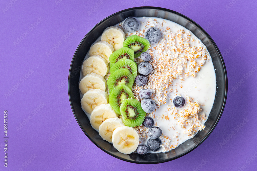 oatmeal bowl fruit breakfast vegetable milk, lactose free, banana, kiwi, berrie, blueberrie meal snack on the table copy space food background oatmeal bowl fruit breakfast vegetable milk, lactose free, banana, kiwi, berrie, blueberrie meal snack on the table copy space food background