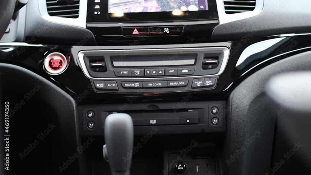 The panel of various buttons a in a modern car. climate control, gearshift , start stop button The panel of various buttons a in a modern car. climate control, gearshift , start stop button