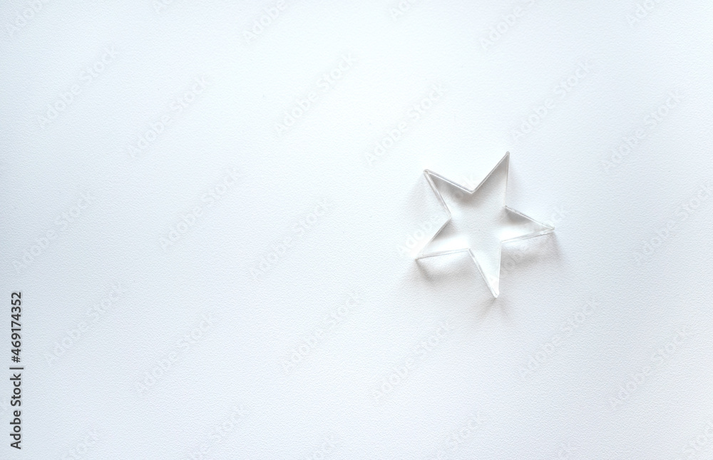 A small glass star on a white isolate.Clean background with a star. The star form. A small glass star on a white isolate.Clean background with a star. The star form.
