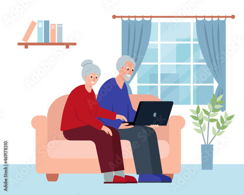 Senior elderly people sitting on sofa with laptop in room.