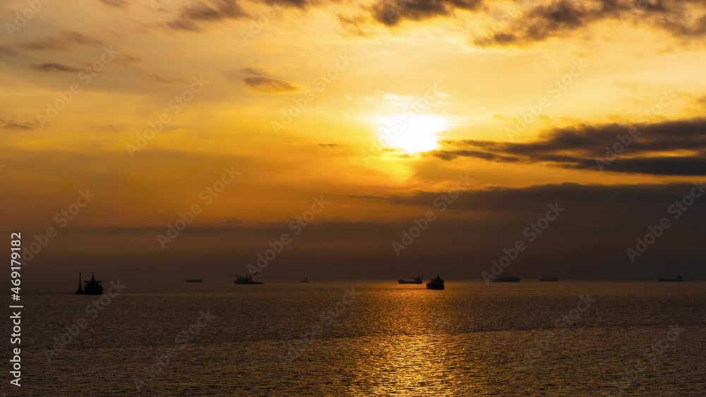 Evening to night timelapse of a beautiful sunset in the sea and ships. Evening turns into night. Evening to night timelapse of a beautiful sunset in the sea and ships. Evening turns into night.