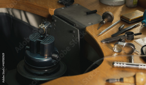 Goldsmith at work. Jeweler's workbenche with different tools. Desktop for craft jewelry making with professional tools.