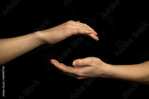 Hand sphere or circle gesture isolated on a black background