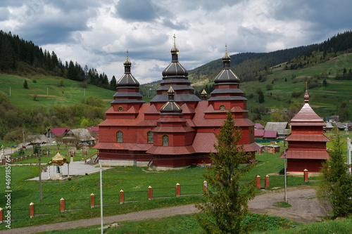 Red church in The Volosianka village in Carpathian Mountains, Ukraine photo