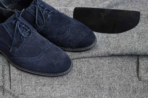 Fotografering Dark blue suede derby shoes on grey tweed fabric background