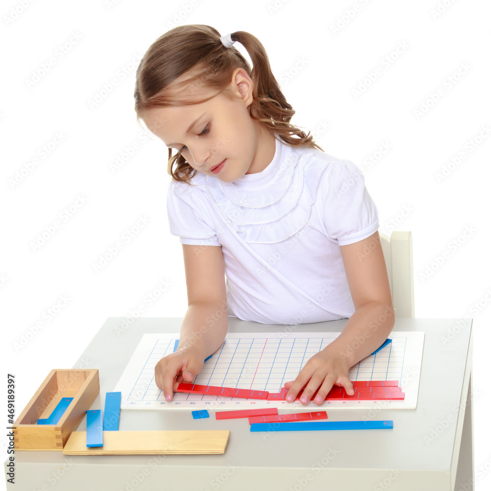 A little girl is studying Montessori stuff. A little girl is studying Montessori stuff.