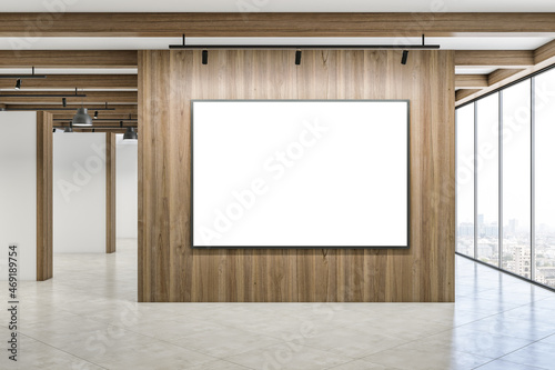 Modern concrete interior with mock up poster on empty wooden wall, panoramic window with city view and daylight. Minimalism concept. 3D Rendering.