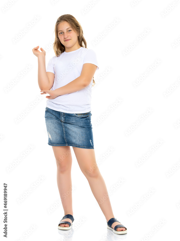 Little school girl pointing to her empty white t-shirt.