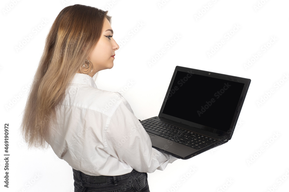 Woman laptop. Girl stands with open laptop. Computer is portable in hands of girl. Notebook screen is off. Businesswoman with laptop with her back to camera. Place for software demonstration. Woman laptop. Girl stands with open laptop. Computer is portable in hands of girl. Notebook screen is off. Businesswoman with laptop with her back to camera. Place for software demonstration.
