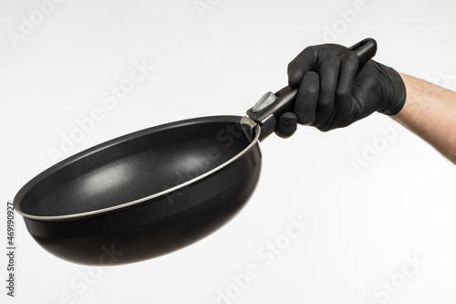 Deep frying pan in man's ha...