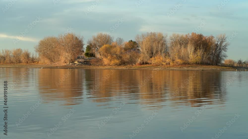 sunset light on a calm lake in November scenery - picnic area in Boyd Lake State Park in northern Colorado sunset light on a calm lake in November scenery - picnic area in Boyd Lake State Park in northern Colorado