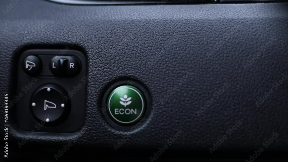 Green ECO button in a modern car. Camera movement from left to right. Green ECO button in a modern car. Camera movement from left to right.
